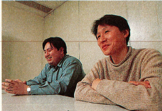 A closeup on Daiichi Katagiri and Hiroshi Kataoka at a table